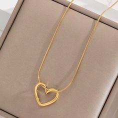 Mini Hollow Twist Heart Pendant Necklace – 18K Gold Plated Stainless Steel Chain for Women and Girls Discover the charm of our Mini Hollow Twist Heart Pendant Necklace. This elegant piece features a delicate heart pendant with a unique twist design, plated in 18K gold on a durable stainless steel chain. Perfect for women and girls who adore minimalist and aesthetic jewelry, this necklace is a standout accessory for any occasion. Ideal for enhancing your everyday look or adding a touch of sophist Mother's Day Double Heart Gold Plated Necklace, Valentine's Day Gift Snake Chain Necklace, Gold Snake Chain Jewelry For Valentine's Day, Gold Snake Chain Necklace For Valentine's Day, Gold Snake Chain Necklaces For Valentine's Day, Snake Chain Heart Necklace For Gifts, Gold Double Heart Charm Necklace, Gold Plated Double Heart Necklace, Elegant Valentine's Day Snake Chain Necklace