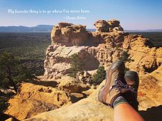 someone's feet resting on the edge of a cliff with a quote above them