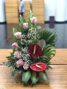 a bouquet of flowers sitting on top of a wooden table