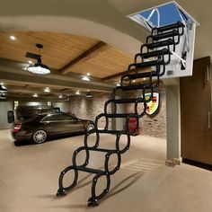 an indoor basketball court with stairs and cars parked in the garage