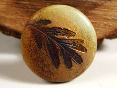 a wooden object with leaves painted on it