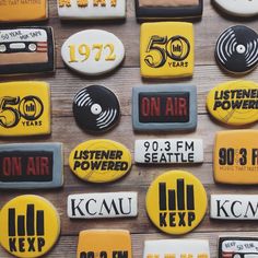 many different types of buttons on a wooden surface with the words, listen to me and 50 years on them