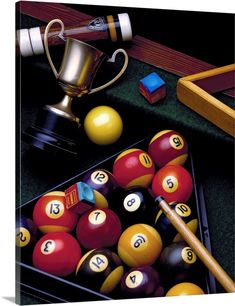 billiards and pool balls with a trophy on the table