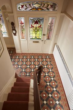 the stairs lead up to an entryway with stained glass windows