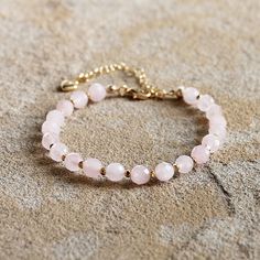 This gorgeous pink Rose Quartz gemstone bracelet features 18K gold filled accents. Stone: Rose Quartz Colour: Pink Main Stone Size: 6mm round  Metal: 18K Gold Filled Length: 19 - 24cm (with extension chain) I love making beautiful, handmade one-of-a-kind pieces of jewellery using semi-precious natural stones and crystals that can be treasured for a lifetime. I can customise a design specifically to meet your needs with your favourite semi-precious stones - ask about a custom design to match a special outfit or for your wedding or bridesmaids. Gold Rose Quartz Bracelets For Jewelry Making, Rose Gold Crystal Bracelet With Round Rose Quartz Beads, Rose Gold Rose Quartz Crystal Bracelet With Round Beads, Rose Gold Rose Quartz Jewelry With 8mm Beads, Elegant Rose Quartz Crystal Bracelet Gift, Elegant Rose Quartz Crystal Bracelet For Gift, Rose Gold Beaded Bracelets With Gemstone Beads, Rose Quartz Gemstone Beaded Bracelets, Rose Gold Bracelets With Gemstone Round Beads