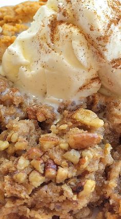 a close up of a plate of food with ice cream on top and nuts in the middle