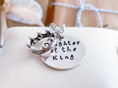 Daughter of the King is hand stamped on the front of this beautiful, sterling silver pendant. You can choose ''bat melech'' OR your very own personalization is on the back. You have the choice of front and back or front only. She knows who she is... more importantly... she knows Who's she is... She is a daughter of the King. FEATURES 1 inch sterling silver hand stamped disk Hammered texture Crown charm - base metal, zinc alloy metal which is lead and nickel free. Choice of chain CHAINS 1. Stainl Inspirational Adjustable Necklace For Personalized Gift, Inspirational Adjustable Necklace For Best Friend, Inspirational Silver Jewelry For Father's Day, Meaningful Adjustable Necklace As Gift, Inspirational Silver Necklace For Father's Day, Spiritual Stamped Jewelry For Mother's Day, Hand Stamped Necklace For Father's Day Gift, Father's Day Engraved Adjustable Necklace, Inspirational Stamped Jewelry For Best Friend Gift