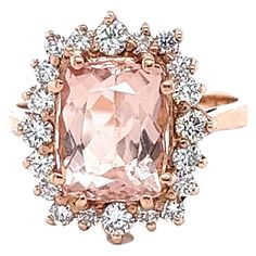 This Morganite Diamond Ring has a 3.16 Carat Emerald Cushion Cut Peach Morganite and is surrounded by 20 Round Cut Diamonds that weigh 0.72 carats. (Clarity: VS, Color: H) The Total Carat Weight of the ring is 3.88 Carats. The morganite measures at approximately 10 mm x 8 mm. It is set in 14K Rose Gold and weighs approximately 5.1 Grams. The ring is a size 7 and can be resized at no additional charge. Morganite Diamond Ring, Peach Morganite, Morganite Diamond, Morganite, Round Cut Diamond, Cushion Cut, Cocktail Rings, Rose Gold Ring, Or Rose