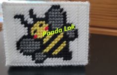 a close up of a knitted object with the words panda lok on it