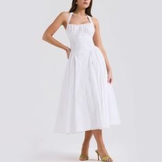 Embrace timeless beauty with this stunning A-line fit and flare midi dress. The halter neck provides a classic yet contemporary look, ideal for any fashionable wardrobe. Delicately crafted with pleated sides on the skirt, this dress combines elegance with a playful twist. Whether you’re attending a garden party, a cocktail event, or a dinner date, this dress is your go-to for effortless style and grace. Color: White, Pink, FloralSilhouette: Fit & FlareLength: MidiMaterial: PolyesterNeckline: Hal Fitted A-line Halter Sundress, Chic A-line Tea Length Dress With Pleated Bodice, Ruched A-line Midi Dress For Cocktail, Chic A-line Tea Length Dress For Garden Party, A-line Midi Dress With Pleated Bodice For Date Night, Feminine A-line Midi Dress With Ruched Bodice, Summer Formal Halter Neck Midi Dress, Chic A-line Midi Dress For Garden Party, Formal Halter Neck Midi Dress For Summer