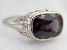 This stunning ring is the perfect blend of classic and modern style. Crafted from solid white gold, the solitaire ring features an elegant east-west spinel held in a bezel setting. Timeless and sophisticated, this exquisite ring is a stunning addition to any jewelry collection.Metal: 18K White GoldGem: Spinel ~3.00 CaratsGem Measurements: 10.8 x 7.9 mm, Cushion CutRing Size: 6.25Marks: "18K" Stamped on the inside band Classic Sapphire Ring With Bezel Setting, Timeless Formal Amethyst Ring, Modern 14k White Gold Sapphire Ring For Formal Occasions, Modern 14k White Gold Sapphire Ring, Elegant Amethyst Ring With Diamond Cut For Anniversary, Modern Sapphire Ring With Center Stone For Formal Occasions, Elegant White Gold Sapphire Ring With Bezel Setting, Modern Sapphire Ring With Bezel Setting For Formal Events, Timeless Sapphire Ring With Bezel Setting For Formal Occasions