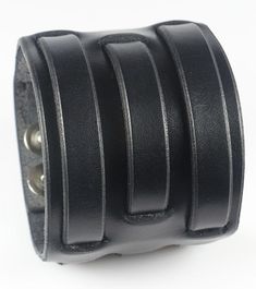 a black leather cuff bracelet with metal rings