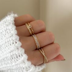 This stylish gem creates an illusion of two rings interlaced with another and crystal encrusted in the front.  MATERIALS: Gold Plated, Brass Cubic Zirconia  Need some jewelry inspiration? Follow us on Instagram @statementGrey Gold Layered Rings, Everyday Ring Inspiration, Dainty Gold Ring Stack, Gold Rings Stack, Stacked Jewelry Rings, Rings Layering, Dainty Ring Stack, Ring Stacking Ideas, Ring Stack Gold