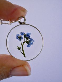 "Our Arrowhead Frame has a modern bohemian feel and is available in a variety of real preserved botanicals. Choose from 24k gold plated or .999 sterling silver plated. The Dandelion Seed symbolizes wishes. The Fern is a symbol of sincerity Forget-me-nots are known as a symbol of lasting friendship, love, and remembrance Lavender is a symbol of devotion Pendant hangs from a gold or silver plated chain, available in 26\" or 30\" lengths. Choose from plain chain or satellite chain, see picture for Delicate Round Pendant Jewelry With Flower Charm, Round Flower Charm Jewelry For Keepsake, Delicate Jewelry With Flower Charm On Round Pendant, Round Keepsake Jewelry With Flower Charm, Minimalist Jewelry With Round Flower Charm Pendant, Delicate Flower Birth Flower Jewelry, Dainty Flower Pendant Jewelry Keepsake, Dainty Flower Pendant Jewelry For Keepsake, Nature-inspired Jewelry With Flower Charm Round Pendant