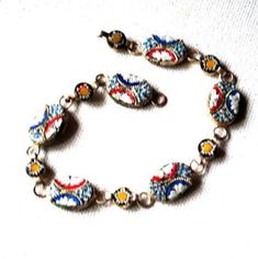 "Art nouveau vintage 40s , silvertone metal , hand made bracelet with a multi color mosaic design. Made in Italy. Large oval and small disc shape links. Blue, red, white , yellow color. Exotic, stylish, unique. Excellent condition. Clean and strong. No missing parts. You can use as a gift. Size 7 1/2 Length:7,5\" Size of the oval link:0,5\"x 0,3\" Size of the disc link: 0,25\" across Thank you for stopping!" Retro Multicolor Bracelet Jewelry, Antique Multicolor Metal Jewelry, Vintage Multicolor Metal Jewelry, Handmade Retro Silver Jewelry, Vintage Multicolor Metal Beaded Bracelets, Multicolor Nickel-free Retro Jewelry, Retro Multicolor Nickel-free Jewelry, Retro Multicolor Round Jewelry, Multicolor Round Retro Jewelry