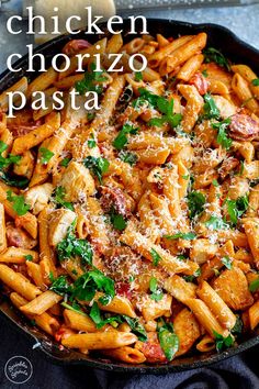 a skillet filled with pasta covered in sauce and parmesan cheese