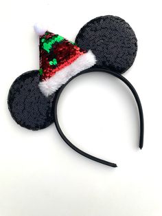 Make the holidays extra merry with these whimsical Holiday Santa Hat Mouse Ears! Delightfully crafted with a Santa Hat atop the mouse ear headbands, these mouse ears will have everyone jingling all the way! These could be worn by everyone including boys as they don’t have a bow! Perfect for your holiday photos and for a trip to the magical park! One size fits all - recommended for ages 3 years and up! Mouse Ears Headband, Jingle All The Way, Ear Headbands, Mouse Ears, Holiday Photos, Santa Hat, Disney World, The Way, Holidays