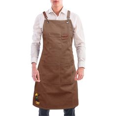 a man is wearing an apron and standing with his hands in his pockets