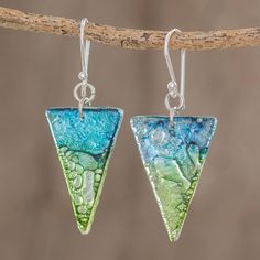 two triangle shaped earrings with green and blue glass beads hanging from silver earwires