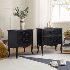 two black nightstands sitting next to each other on top of a white carpeted floor