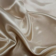 Charmeuse Satin Fabric by the yard, bolt, or wholesale. This Champagne charmeuse silk fabric has a very soft hand and a silky feel. It is light in weight and has beautiful drape that makes it perfect for dresses, special occasion apparels, and gowns. It is also often used for intimate apparels, robes, and pajamas. Size: Sample Swatch (7"x10").  Color: Beige. Wedding Apparel, Crafts Decor, Fashion Illustration Dresses, Fabric Bolts, Wedding Crafts, Fabric Bundle, Satin Wedding, Polyester Satin, Satin Material