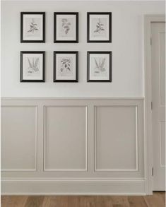 a white room with framed pictures on the wall