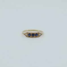 This is Ms. Goodbar, a little like a Mr. Goodbar candy bar in that it's delicious! Amazing blue colored goodness in the middle sandwiched between two diamonds.  The blue sapphires are so rich in this ring, it's sure to be a classic heirloom to be passed down for many generations to come. Details: 14k (available in rose