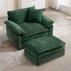 a green chair and ottoman in a living room