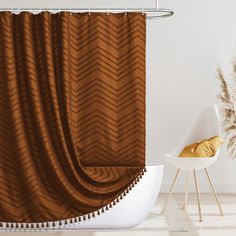 a brown shower curtain sitting next to a white bath tub