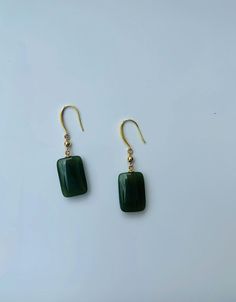 A pair of elegant rectangle-shaped dark green jade cube earrings with 14k gold ear wire. They are made from high-quality real Chinese jade and 925 sterling silver plated with 14k gold. Simple and minimalistic design works great for all sorts of occasions: dating, daily wear, home or office, you name it. Perfect as a gift for your loved ones or yourself. Highlights: ♥ High-quality materials Hand-made with quality dark green jade, paired with 925 sterling silver plated with 14k gold. Ensure long last wear and they are friendly for sensitive skin. ♥ Simple and minimalistic design Great for all sorts of occasions and perfect for gifting  ♥ Measurements Each drop is measured 1.5cm diameter and 2.5cm long. ♥ 100% Satisfaction Guarantee Gift-worthy packaging included! Please include a message if Cheap Green Minimalist Jewelry, Cheap Green Danglers Perfect As Gifts, Handmade Jade Earrings, Cheap Bohemian Green Earrings, Affordable Handmade Jade Earrings, Affordable Jade Bead Earrings, Cheap Everyday Green Earrings, Green Rectangular Earrings For Formal Occasions, Elegant Green Rectangular Earrings