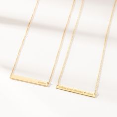 The Skinny Bar Necklace is both classic and modern. It looks great with a t-shirt or a cocktail dress. Personalize this piece with kids names, wedding dates, birthdays - the possibilities are endless, and did we mention it's reversible?! available in 14k yellow, 14k rose and 14k white gold skinny bar is 1.5″ L x 3/16″ W and is reversible back text lowercase font and center aligned only (25 characters max) to enter symbols, copy & paste from here:  +  &   /  –  .  #  °  hangs on a cable chain available in adjustable lengths of 14"-16" or 16-18".  View our necklace size guide here. Made in the USA Wedding Dates, Bar Necklaces, Wedding Song, Nameplate Necklace, Gold Bar Necklace, Kids Names, Rose Gold Chain, Necklace Size, Yellow Gold Chain