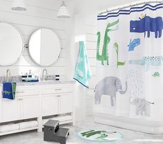 a bathroom with two round mirrors on the wall and a shower curtain in the middle