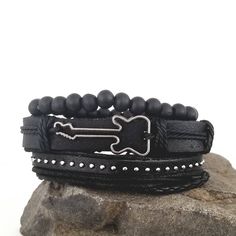 This guitar bracelet set complements your love for music. The all black bracelets are versatile and can be worn with any of your outfits. You can wear the bracelets together as a set or each one separately to create a different everyday. Every set is handmade with care. Product Information *Set comes with 3 bracelets *Material: leather/PU leather *Metals Type: alloy *Clasp Type: sliding knots *Adjustable Length: around 7 - 8.5 inches Adjustable Black Punk Wristband, Black Band Wristband For Concerts, Black Rock Style Wristband As Gift, Edgy Band Bracelet For Concerts, Edgy Band Bracelet For Concert, Black Punk Bracelets For Festival, Black Punk Festival Bracelets, Casual Black Bracelets For Festival, Edgy Adjustable Black Wristband