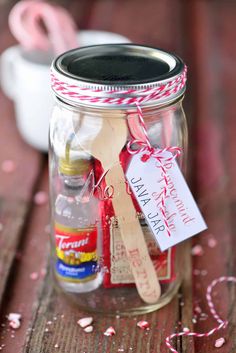 a mason jar filled with candy canes and other confetti ingredients for valentine's day