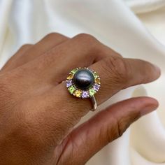 Black Pearl Ring set with a Natural Pearl in an AAA grade & natural black color, at 10mm diameter, from Japan, surrounded with Natural Citrine, Amethyst & Peridot, at 3mm each, 1.5 Carat combined, from Brazil. Band width 1.5mm. Pearl Flower Ring made of Solid 925 Sterling Silver ☞ made to last. Matching Earrings: www.etsy.com/listing/257621328 Matching Pendant: www.etsy.com/listing/558058800 June, November, February & August Birthstone * Genuine & Natural Stones * D E T A I L S ✓ Adina Stone GIF Luxury Mother Of Pearl Gemstone Rings, Luxury Pearl Birthstone Ring, Luxury Round Pearl Ring With Cabochon, Luxury Multi-stone Pearl Ring In Fine Jewelry Style, Luxury Oval Cabochon Pearl Ring, Luxury Round Pearl Birthstone Ring, Luxury Multi-stone Pearl Ring Fine Jewelry, Luxury Multi-stone Heirloom Pearl Ring, Luxury Classic Multi-stone Pearl Ring