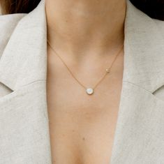 This Gold Round Pearl Necklace is a timeless piece. Its delicate silhouette and creative stone placement will add a playful touch to any look, while its easy-to-wear design makes it perfect for everyday outfits. It features a brilliant white topaz gemstone that dances above the round mother of pearl pendant, reminding you to enjoy the little surprises life has to offer. 8mm mother of pearl 3mm white topaz gemstone 16"-18" adjustable chain length Recycled 14k gold over sterling silver (vermeil) C Handwritten Gifts, Mother Of Pearl Pendant, Sustainable Accessories, Mother Of Pearl Necklace, Vegan Gifts, Quick Gifts, Cozy Gift, Jewelry Studio, Topaz Stone