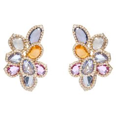 18 Karat Yellow Gold 13.56 Carat Multi-Sapphire and Diamond Cocktail Stud Earrings This illustrious rainbow multi-sapphire and diamond stud earring is exquisite. The uneven mix shape rose cut multi-sapphires are skillfully placed one over the other and angled marvelously, as they distinctly highlight each collate. The differing layers enhance the multi-sapphires all the way while the single row cluster of pave set diamonds border each sapphire and profoundly make it a modern and uniquely contemp Multi Sapphire Earrings, Multi Sapphire Jewellery, Saphire Jewelry, Egyptian Inspired Jewelry, Sapphire Jewellery, Multi Coloured Necklaces, Contemporary Earrings, Multi Sapphire, Halloween Painting