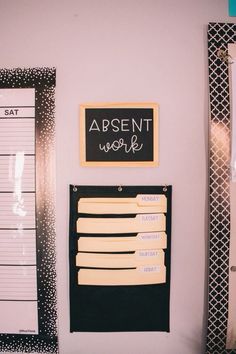 a bulletin board is hanging on the wall next to a ruler and other office supplies