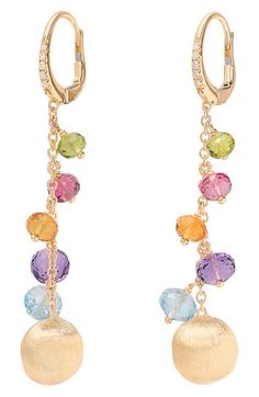 Twinkling pavé diamonds and a hand-engraved bead of 18-karat gold flank this captivating pair of drop earrings featuring faceted stones in exquisite colors. 2 1/8" drop; 3/8" width Lever-back closure Total diamond weight: 0.07ct. 18k gold/London blue topaz/blue topaz/quartz/tourmaline Made in Italy >Diamond Guide Marco Bicego, Diamond Guide, London Blue, London Blue Topaz, Hand Engraving, Pave Diamonds, Blue Topaz, Tourmaline, Topaz