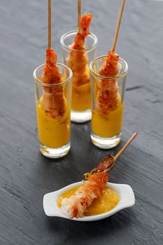 shrimp skewers are served in small cups