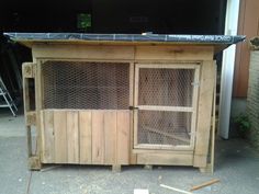 an outdoor kitchen made out of wood and wire