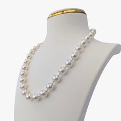 This necklace radiates elegance and sophistication with its magnificent and airy design. It features exquisite Australian White South Sea pearls with a fine luster and clean surfaces with only very minor inclusions. The pearls are round/almost round, ranging in size from 9 to 11mm. They threaded intermittently with 2.5-3.mm baby Akoya pearls, round, with high luster and green and blue obertone. The necklace is secured with a 14K yellow gold clasp that is embellished with 0.11ct diamonds (NC/SI). Elegant Round Pearl Necklace With High Luster, Luxury Pearl White Necklace For Formal Occasions, Elegant Pearl Necklaces With Round Beads, Elegant Single Strand Round Necklace, Classic Pearl White Necklace With High Luster, White Gold Pearl Necklaces With Round Beads, Elegant Jewelry With High Luster Round Beads, Formal Akoya Pearl Necklace With High Luster, Formal Single Strand Pearl Necklace In White Gold