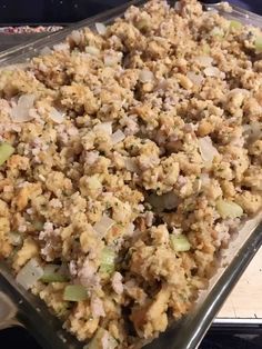 a casserole dish with meat and vegetables in it on a counter top, ready to be eaten