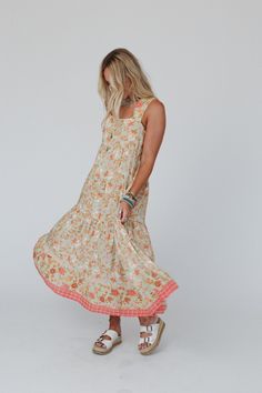 Whether you're dressing up for a special event or just want to add some boho flair to your everyday look, the Paradise Sunrise Maxi Dress is sure to make a statement! Lightweight, flowy, woven fabric with an eye-catching floral print Flattering empire maxi dress silhouette Square neckline and backline with thick shoulder straps Gathered tiers for added boho style Bottom hem with so pretty floral border print Pair with: Eye Of The Sun Padded Bralette, Sunlit Sands Panama Hat and Turquoise Cascade Boho Essentials, Empire Maxi Dress, Bralette Outfit, Padded Bralette, The Paradise, Border Print, Dress Silhouette, Floral Border, New Tops