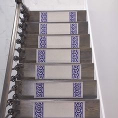 a set of stairs with blue and white carpeted treads on each handrail