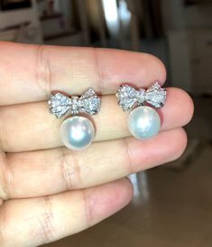 We are presenting you A PAIR OF matching SOUTH SEA PEARLS with LUSTROUS WHITE color. SET IN HANDCRAFTED, 18K SOLID GOLD DROP EARRINGS. ACCENTED WITH 64 E/VS, SPARKLING ROUND BRILLIANT DIAMONDS! IN CASE OF RETURN FOR US BUYERS. BUYERS MAY SEND THE ITEMS BACK TO OUR US-BASED OFFICE IN SALT LAKE CITY, UTAH ONLY ONE ITEM AVAILABLE!! NO DUPLICATES!! WHAT YOU SEE IN THE PICTURES IS WHAT YOU WILL GET SOLIDLY HANDCRAFTED EARRINGS! SUGGESTED RETAIL VALUE: $9,880 PEARLS: Size: 12 mm Shape: Oval/Round Colo White Cubic Zirconia Party Earrings, White Teardrop Pearl Earrings For Party, Luxury White Pearl Earrings For Party, White Cubic Zirconia Bridal Earrings For Anniversary, Elegant Diamond White Bridal Earrings As Gift, Pearl White Bridal Earrings For Anniversary, White Round Bridal Earrings For Party, Elegant Diamond White Bridal Earrings, Luxury White Pearl Earrings In Sterling Silver