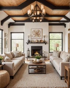 a living room with two couches and a fire place in the middle of it