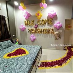 a bed room with a neatly made bed and balloons