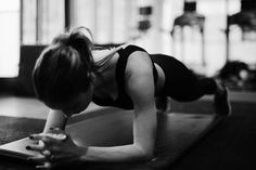 a woman is doing push ups on her yoga mat