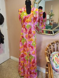 Stunning maxi Hawaiian print floral dress. Bright pinks, yellows, reds and oranges. Back nylon zipper. Beautiful high collar neckline. Perfect for your summer luau Made by BJs Hawaii. 20" chest, 15" waist, shoulder to hem 57". Polyester. Multicolor Sleeveless Hawaiian Dress, Sleeveless Hibiscus Print Maxi Dress For Spring, Spring Sleeveless Maxi Dress With Hibiscus Print, Vibrant Short Sleeve Maxi Dress With Floral Print, Sleeveless Maxi Dress With Hibiscus Print, Fitted Multicolor Hawaiian Dress, Tropical Hibiscus Print Maxi Dress For Spring, Fitted Multicolor Tropical Maxi Dress, Vibrant Fitted Floral Print Maxi Dress